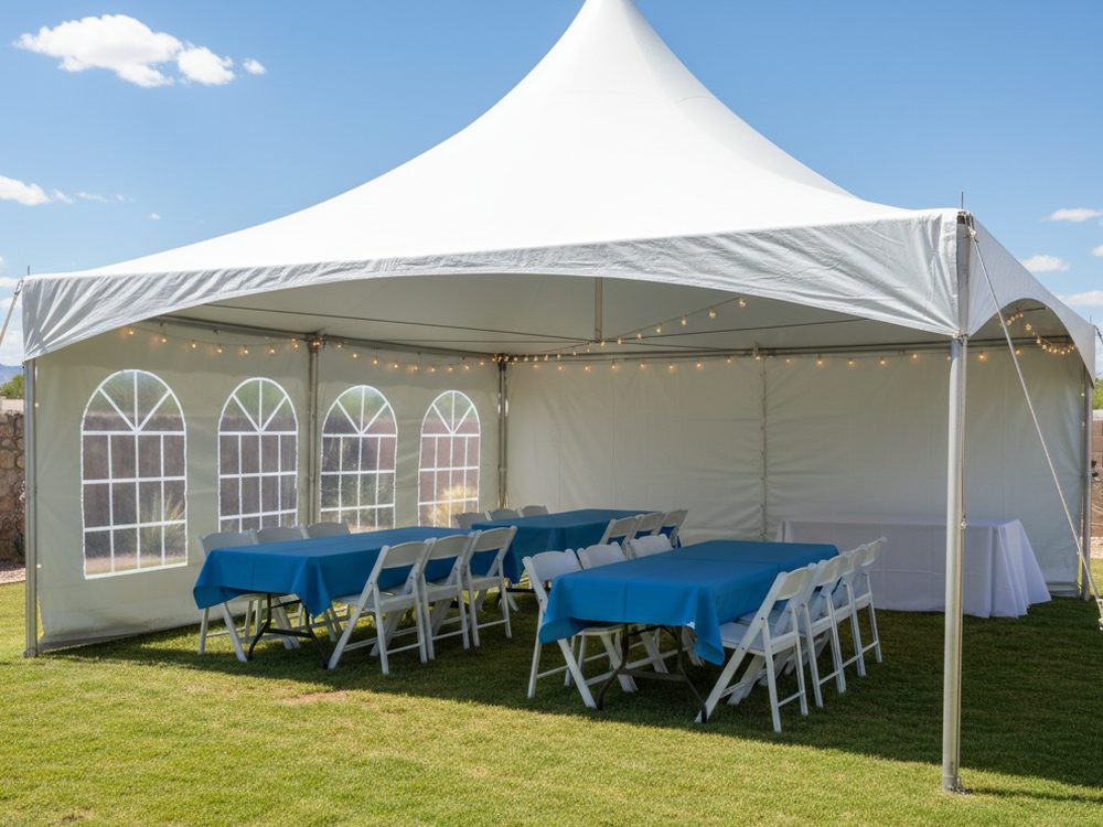 A single 20 by 20 high-peak tent on grass with blue-linen banquet tables and white folding chairs.